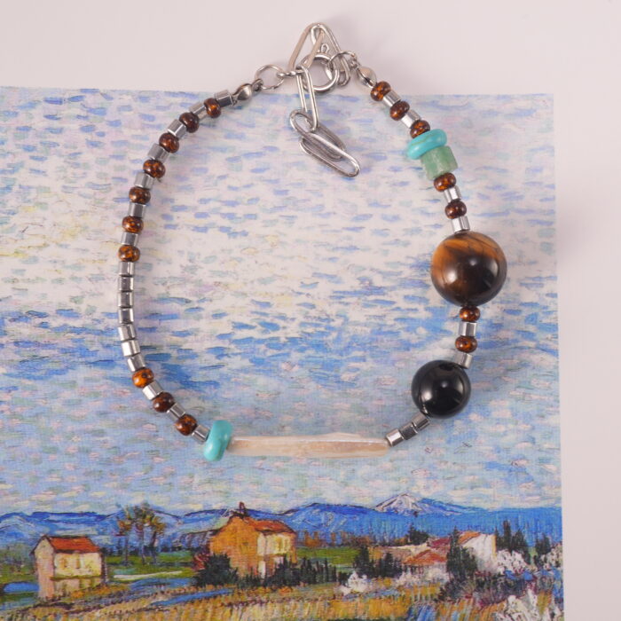 "Tiger eye and turquoise bracelet placed beside journal and crystals, ideal for meditation and daily energy rituals