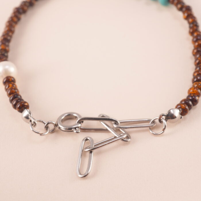 Close-up view of the Tiger Eye, Turquoise, and Pearl Bracelet, emphasizing the quality of the natural gemstones and adjustable design.
