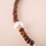 Close-up view of the Tiger Eye, Turquoise, and Pearl Bracelet, emphasizing the quality of the natural gemstones and adjustable design.