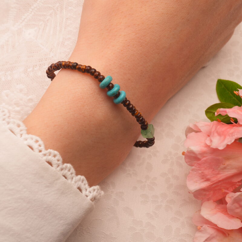 Model showcasing the Tiger Eye, Turquoise, and Pearl Bracelet on wrist, highlighting its minimalist design and healing properties.