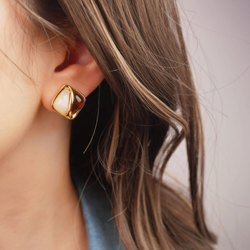 Model wearing the two-tone crystal studs to show size and natural contrast