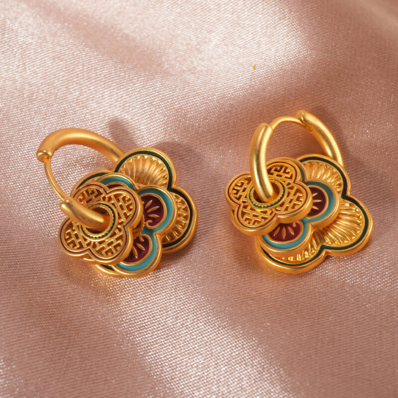 Red and blue color block floral hoop earrings on a clean background