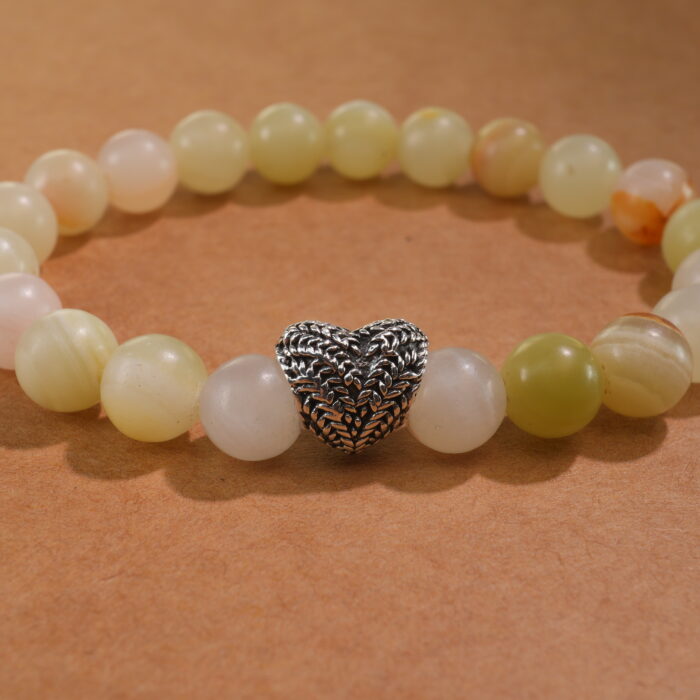 Close-up of Afghan jade bracelet with soft green translucent beads.