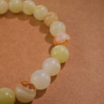 Close-up of Afghan jade bracelet with soft green translucent beads.