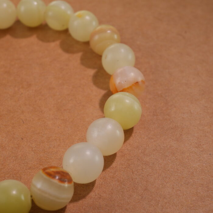 Close-up of Afghan jade bracelet with soft green translucent beads.