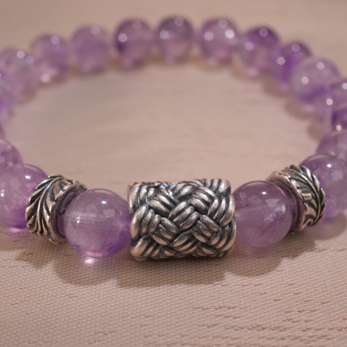 Close-up of second amethyst bracelet showing bead shape and deep hue.