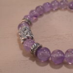 Close-up of second amethyst bracelet showing bead shape and deep hue.
