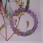 Second amethyst bracelet placed in natural light with minimal background.