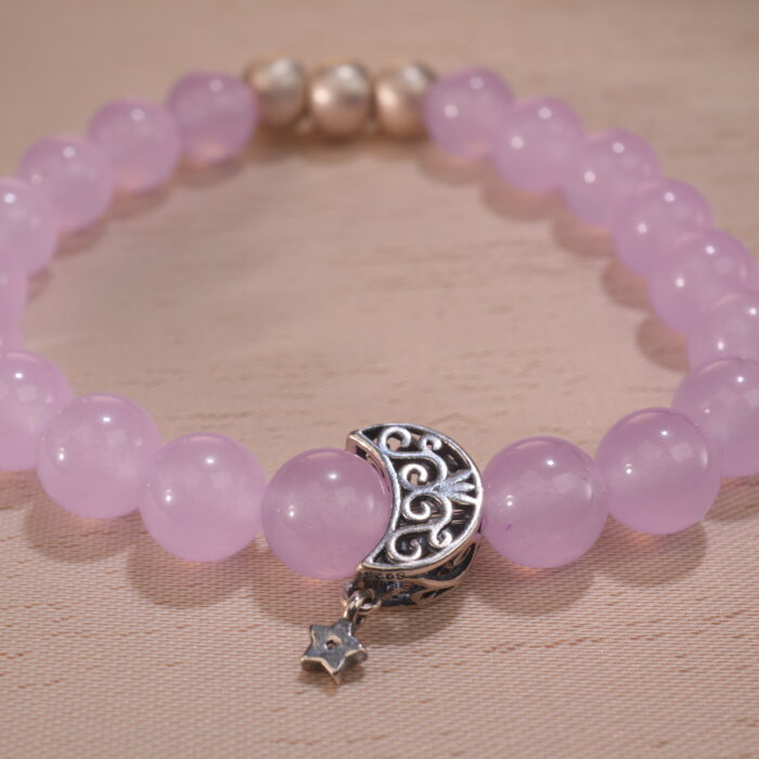 Close-up of amethyst bracelet with translucent purple crystal beads.