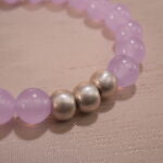 Close-up of amethyst bracelet with deep purple crystal beads.