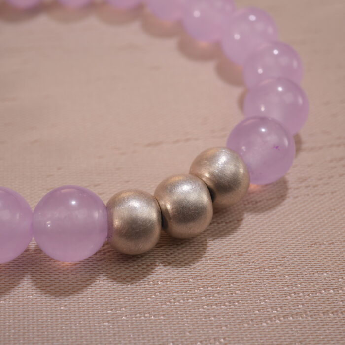 Close-up of amethyst bracelet with deep purple crystal beads.