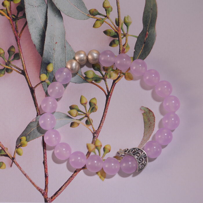 Amethyst bracelet displayed in natural light with soft neutral background.