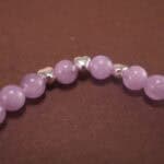 Close-up of amethyst bracelet with silver accents.