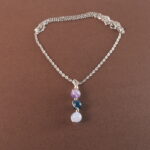 Aquarius zodiac necklace with amethyst, blue apatite, and aquamarine gemstones.