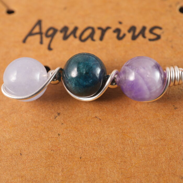 Close-up of Aquarius necklace showing amethyst, blue apatite, and aquamarine beads.