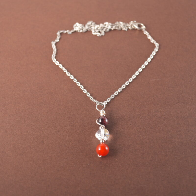 Aries zodiac necklace with amethyst, clear quartz, and red agate gemstones.
