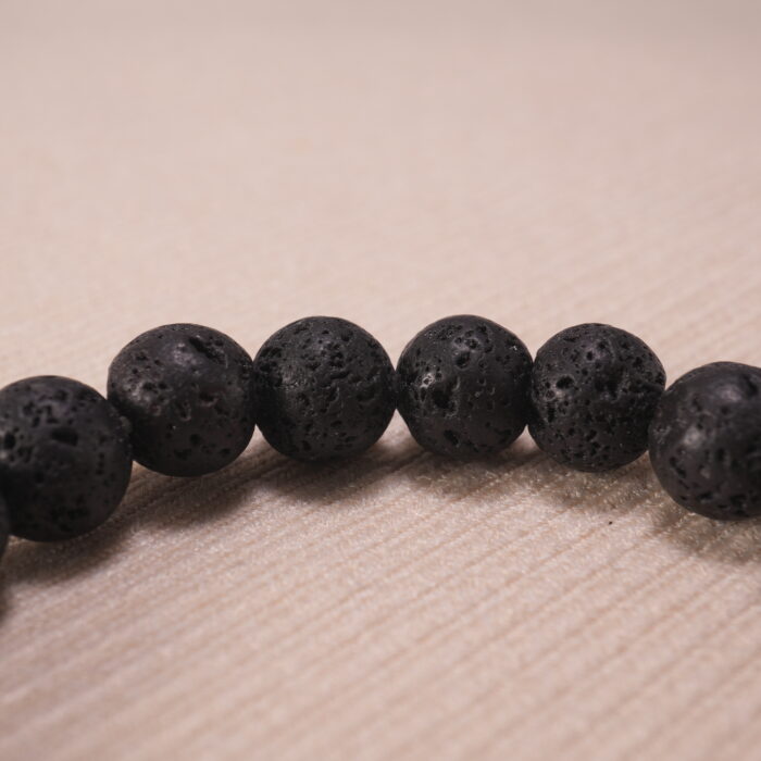 Close-up of all-black lava stone bracelet.