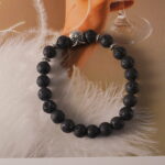 Black lava bracelet in natural light with textured finish.