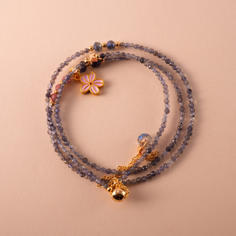 Versatile necklace made with black rutilated quartz and rhodochrosite, wearable as a three-wrap bracelet.