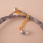 Close-up of the gemstone textures and metallic clasp.