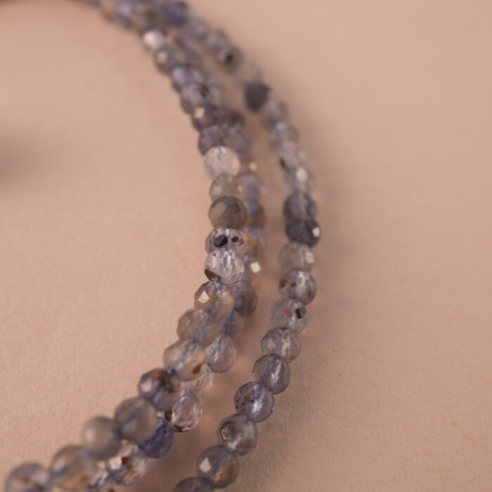 Close-up of the gemstone textures and metallic clasp.
