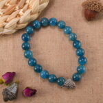 Blue apatite bracelet in soft daylight with ocean-blue tones.