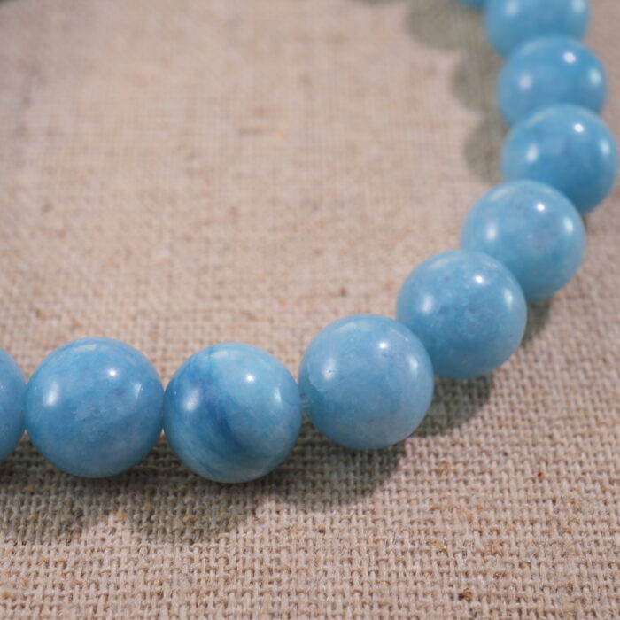 Close-up of blue chalcedony bracelet with soft sky-blue translucent beads.