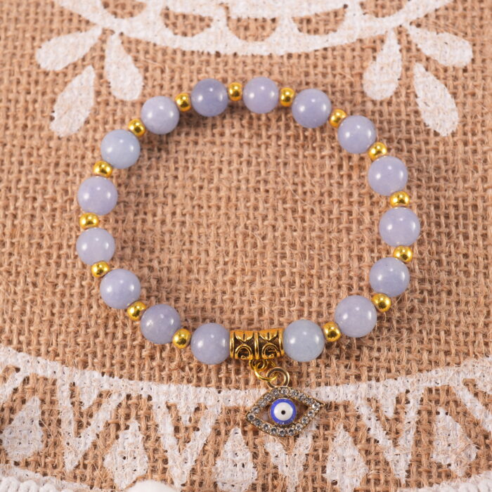 Blue chalcedony evil eye bracelet in natural light with soft hues.