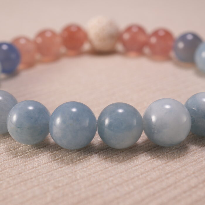 Close-up of blue chalcedony bracelet with strawberry quartz and lava.