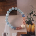 Bracelet in daylight with soft blue and pink gemstone tones.