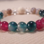 Close-up of blue heart agate bracelet with quartz and lava stone.