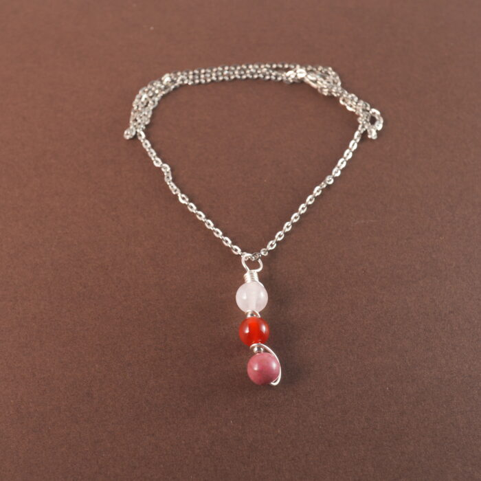 Cancer zodiac necklace with clear quartz, red agate, and rhodochrosite gemstones.