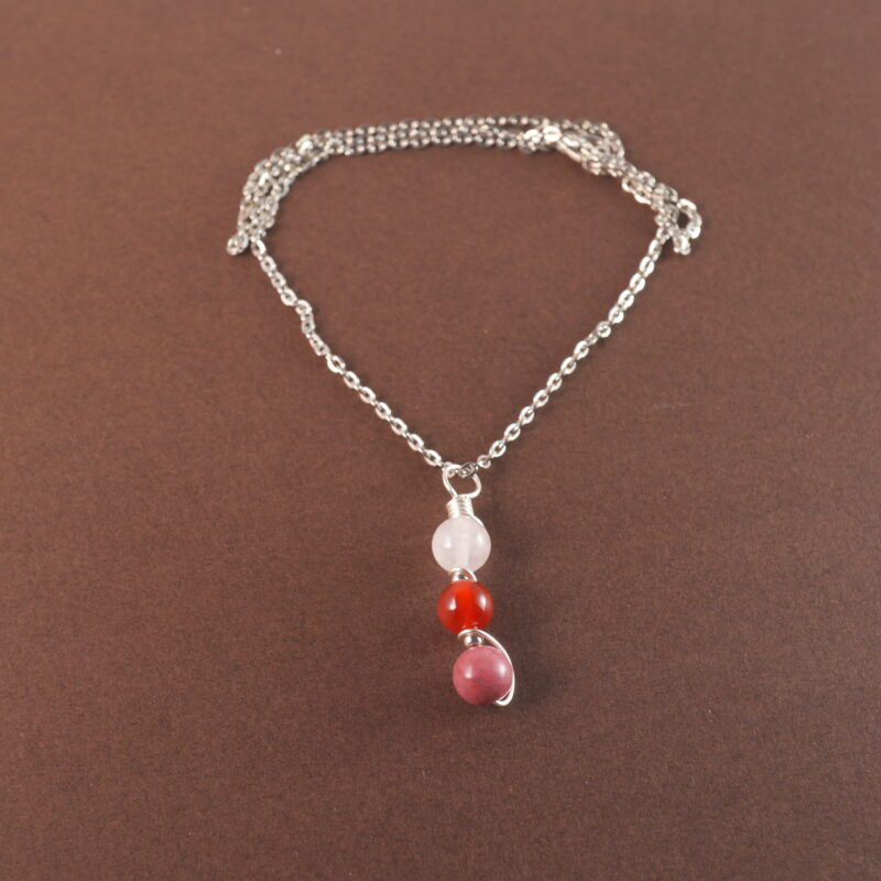 Cancer zodiac necklace with clear quartz, red agate, and rhodochrosite gemstones.