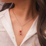 Model wearing Cancer zodiac necklace with clear quartz, red agate, and rhodochrosite.