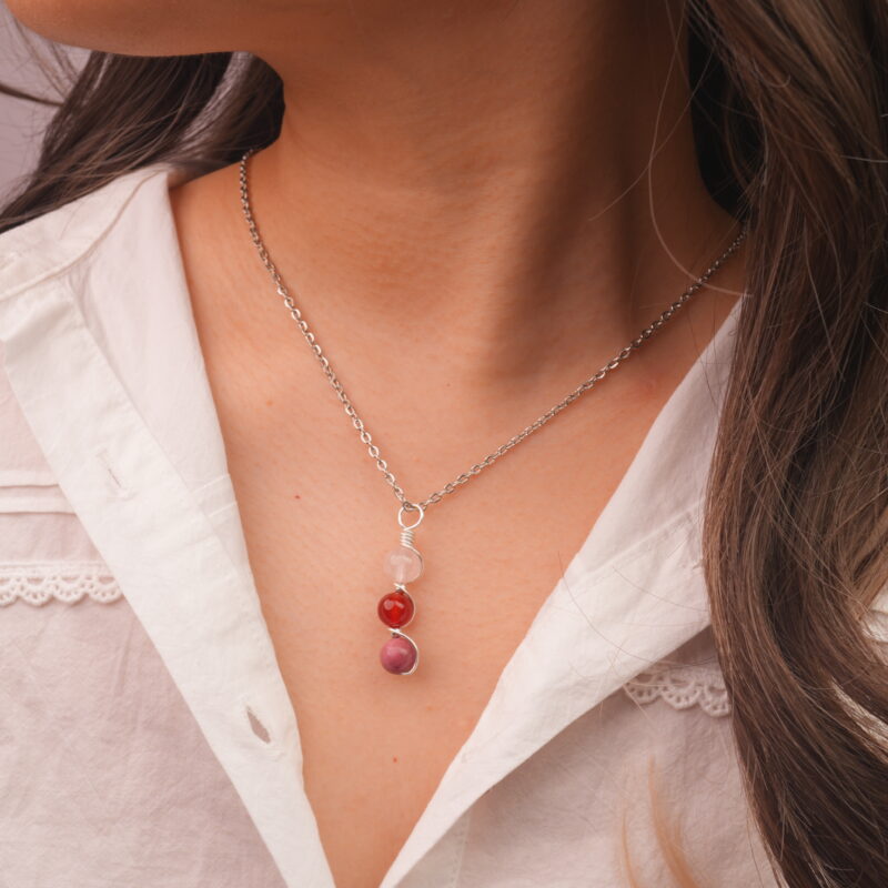 Model wearing Cancer zodiac necklace with clear quartz, red agate, and rhodochrosite.