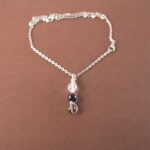 Capricorn zodiac necklace with clear quartz, obsidian, and smoky quartz gemstones.