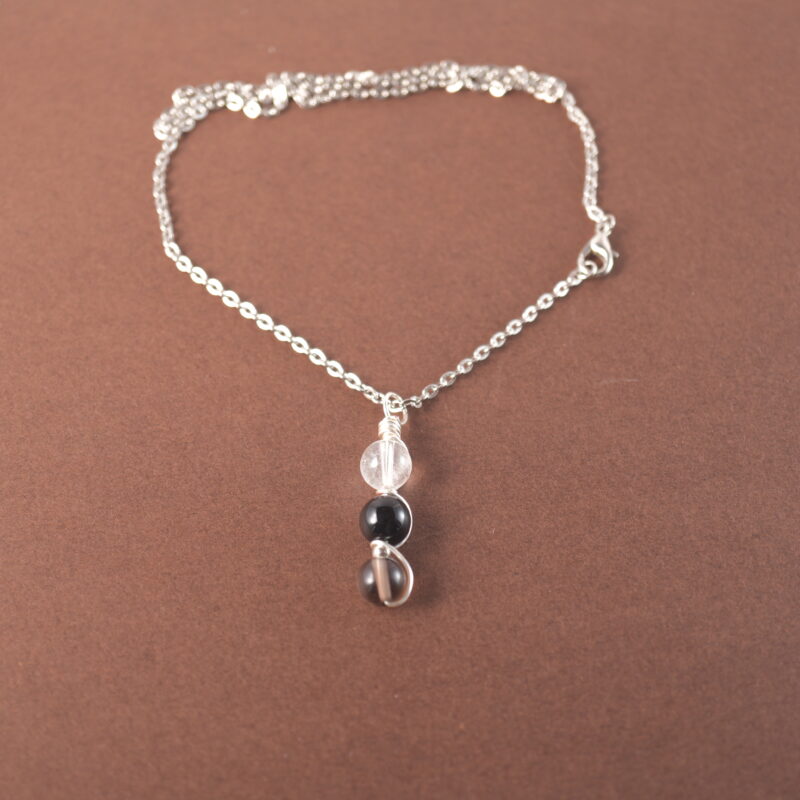 Capricorn zodiac necklace with clear quartz, obsidian, and smoky quartz gemstones.