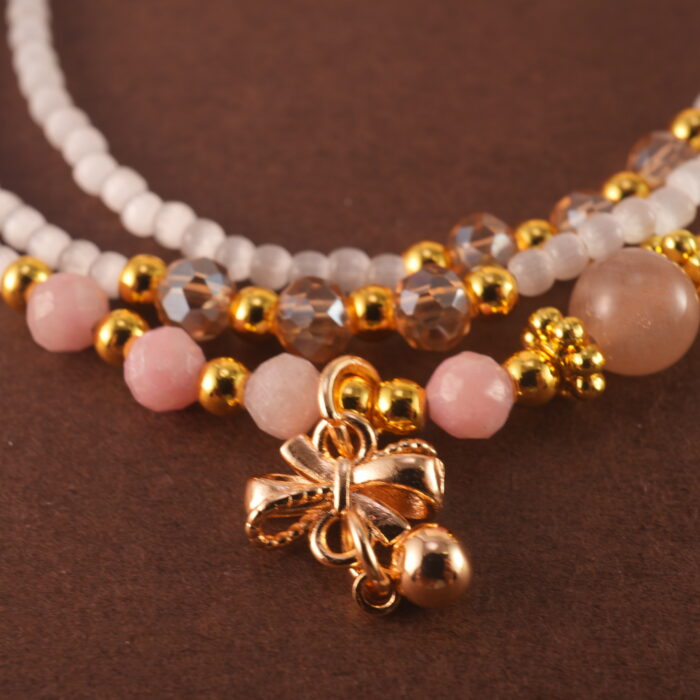 Macro shot of the Cat's Eye and Rhodochrosite beads with silver accents.