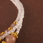 Macro shot of the Cat's Eye and Rhodochrosite beads with silver accents.