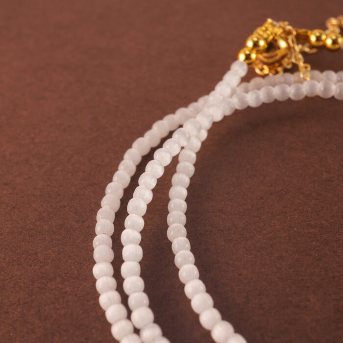 Macro shot of the Cat's Eye and Rhodochrosite beads with silver accents.