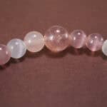Close-up of cat’s eye and strawberry quartz bracelet with silver.