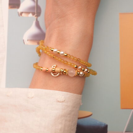 Model showcases the piece as a wrap bracelet, highlighting its luminous, natural stones.
