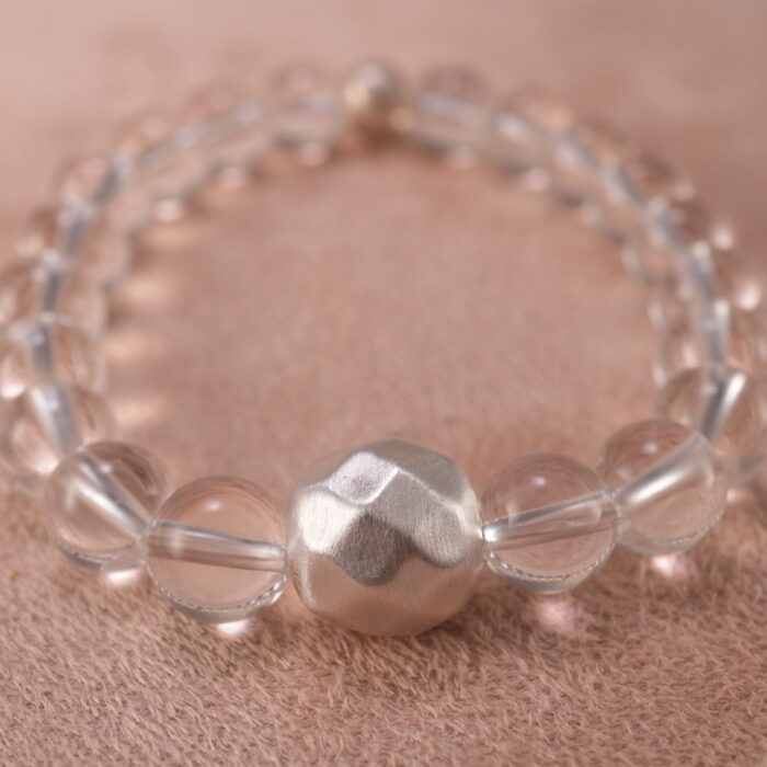 Close-up of clear quartz bracelet showing pure transparent crystal beads.