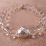 Close-up of clear quartz bracelet with S925 silver details.