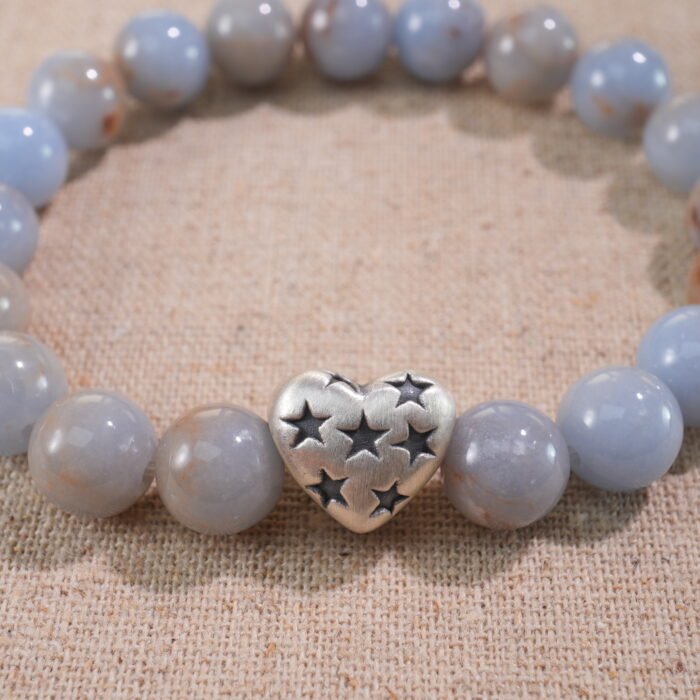 Close-up of cream chalcedony bracelet with smooth warm beige tones.