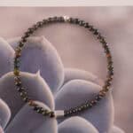 Tourmaline bracelet in natural light showing dark green and blackish tones.