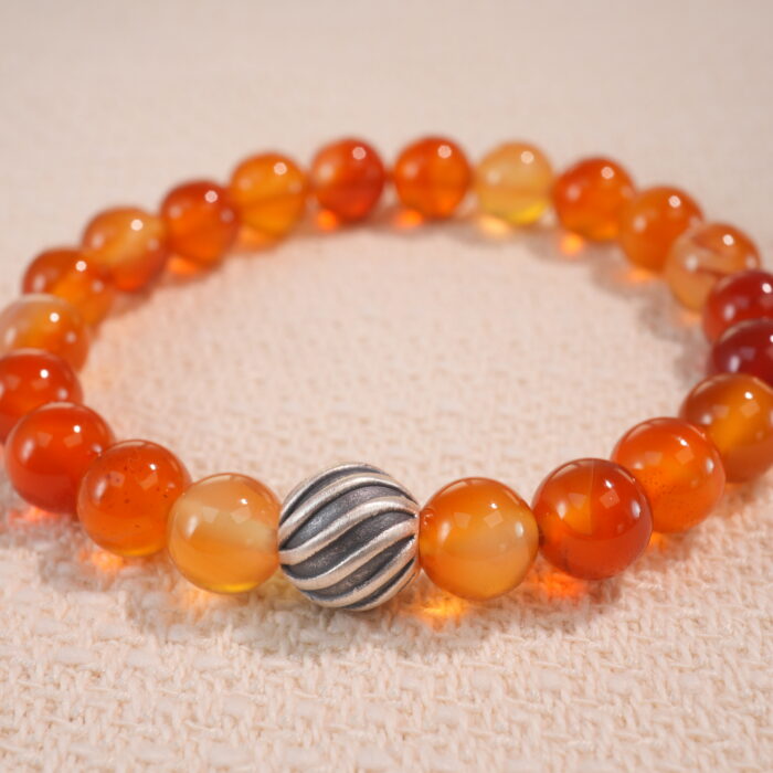 Close-up of first flower red agate bracelet with rich marbled patterns.