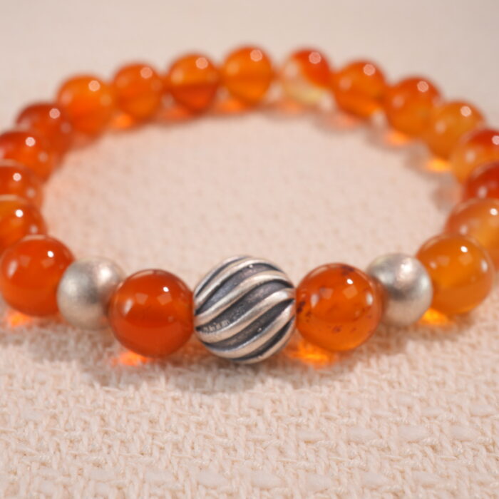 Close-up of second flower red agate bracelet with slightly varied tone.