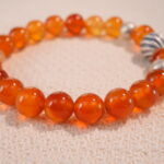 Close-up of second flower red agate bracelet with slightly varied tone.