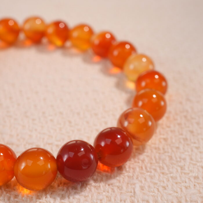 Close-up of flower red agate bracelet with marbled red tones.